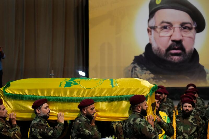 Hezbollah fighters carry the coffin of Fouad Shukur (AP Photo/Hussein Malla)