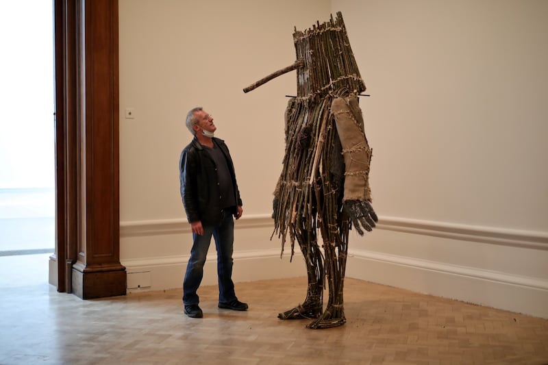 Tim with a sculpture from a previous Mummers-themed exhibition, Lifting the Curse