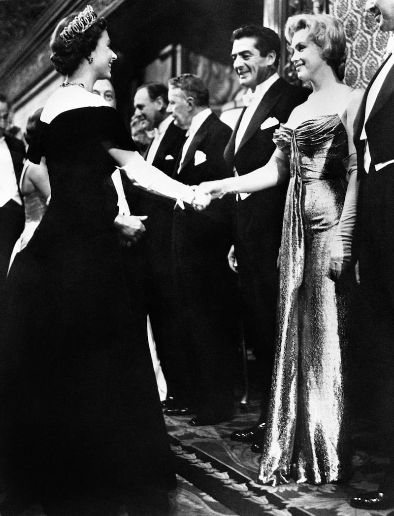 Marilyn Monroe shakes hands with the late Queen at the 1956 Royal Film Performance of The Battle Of The River Plate, at the Empire Theatre, Leicester Square