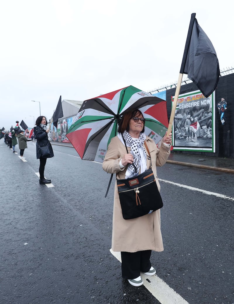 Supporters of the Palestinian people hold a black flag protest at the Murals on the Falls Road in West Belfast.
PICTURE COLM LENAGHAN