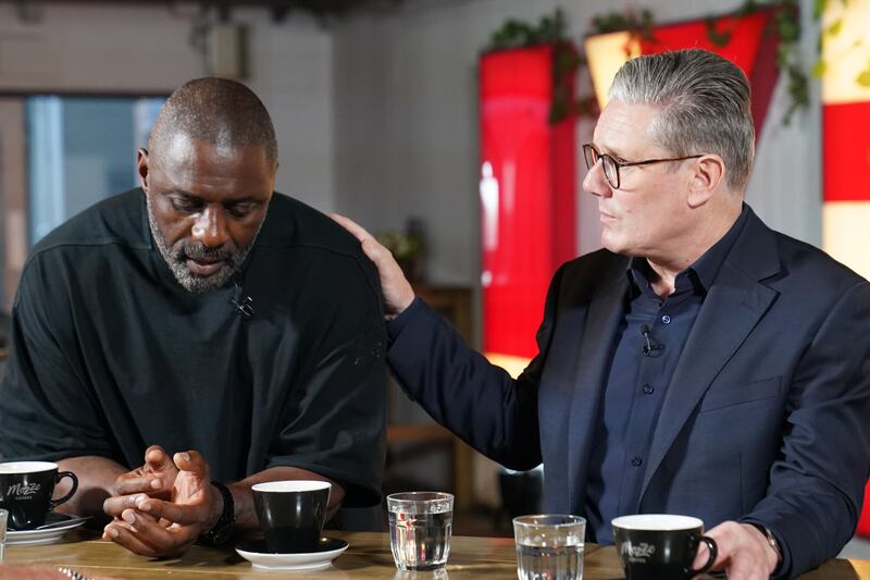 Labour leader Sir Keir Starmer rests his hand on the shoulder of Idris Elba, as they meet families of knife crime victims