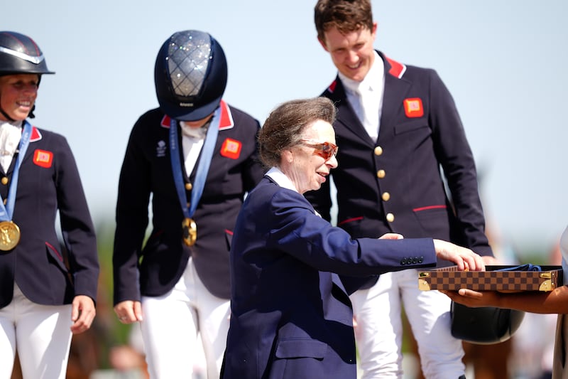 Anne presenting gold medals to Great Britain’s Rosalind Canter, Laura Collett and Tom McEwen following the Eventing Team Jumping Final at the Olympics