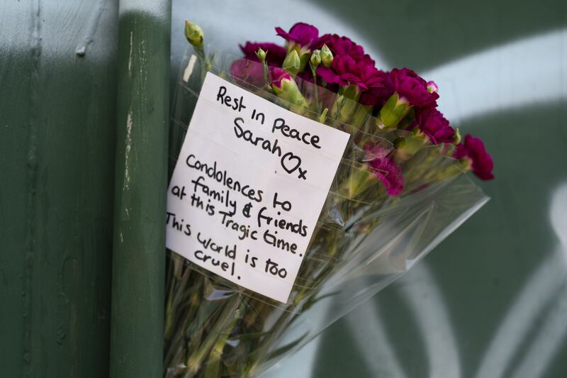 Floral tributes at the scene in Rowdown Fields, in New Addington, south London, where remains belonging to Sarah Mayhew, 38, were found