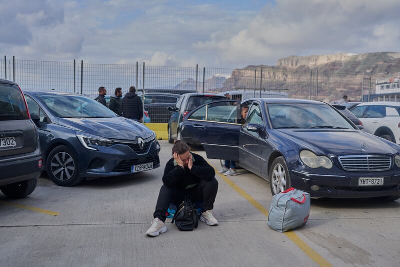 A passenger waits for a ferry bound for the Greek mainland in the earthquake-struck island of Santorini, Greece (Petros Giannakouris/AP)