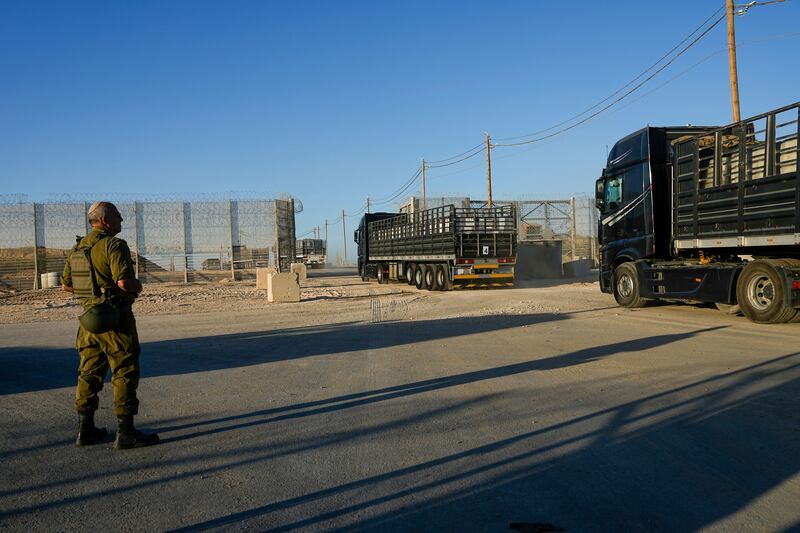 Trucks carrying humanitarian aid cross into the Gaza Strip from Erez crossing in southern Israel (Tsafrir Abayov/AP)