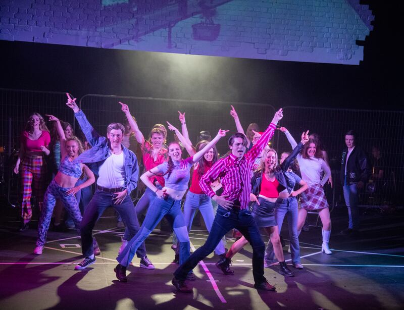 Image of young performers dancing on a stage.