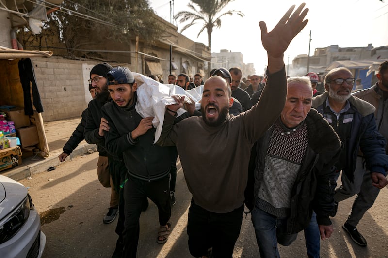 Mourners carry the bodies of five Palestinian journalists (Abdel Kareem Hana/AP)