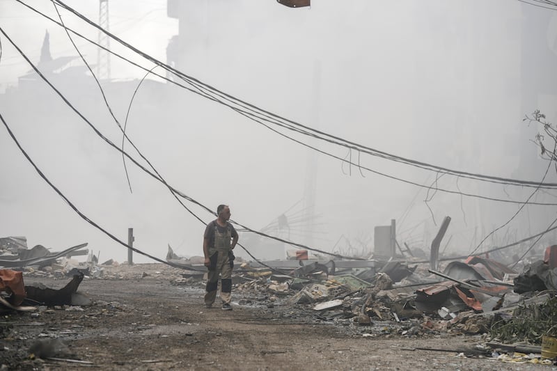 A man walks past buildings destroyed by an Israeli air strike in Choueifat, south-east of Beirut (Bilal Hussein/AP)