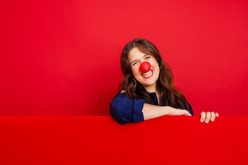 LONDON, UNITED KINGDOM – DECEMBER 2023: TV Personality and comedian, Rosie Jones ssupports Red Nose Day 2024 by wearing one of the new Red Noses. Plastic free, recyclable and plant-based, the Noses are available from Amazon, the official home of the Red Nose. Taken in London on the 12th December 2024. (Photo by Rebecca Naen/Comic Relief)