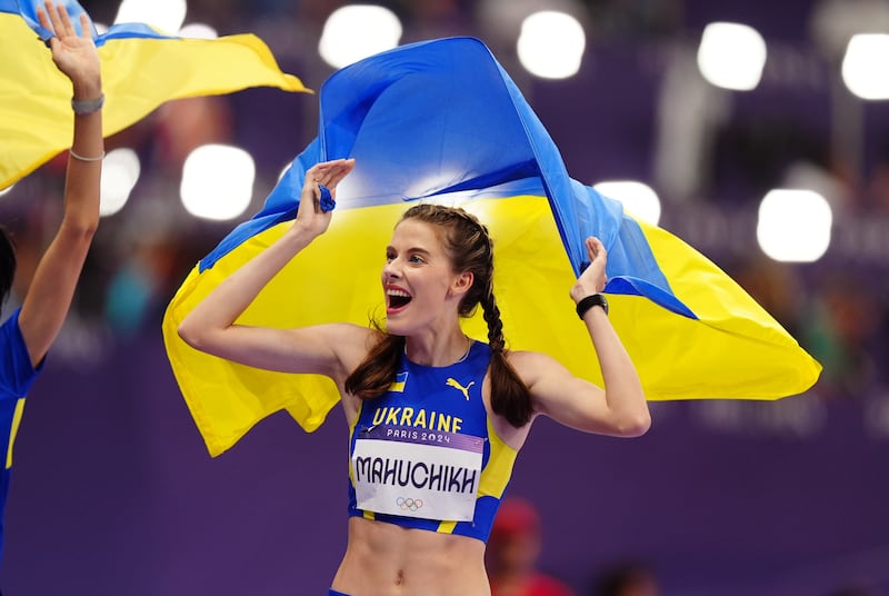 Yaroslava Mahuchikh wore blue and yellow eye-liner and a berry lip at the Olympic Games