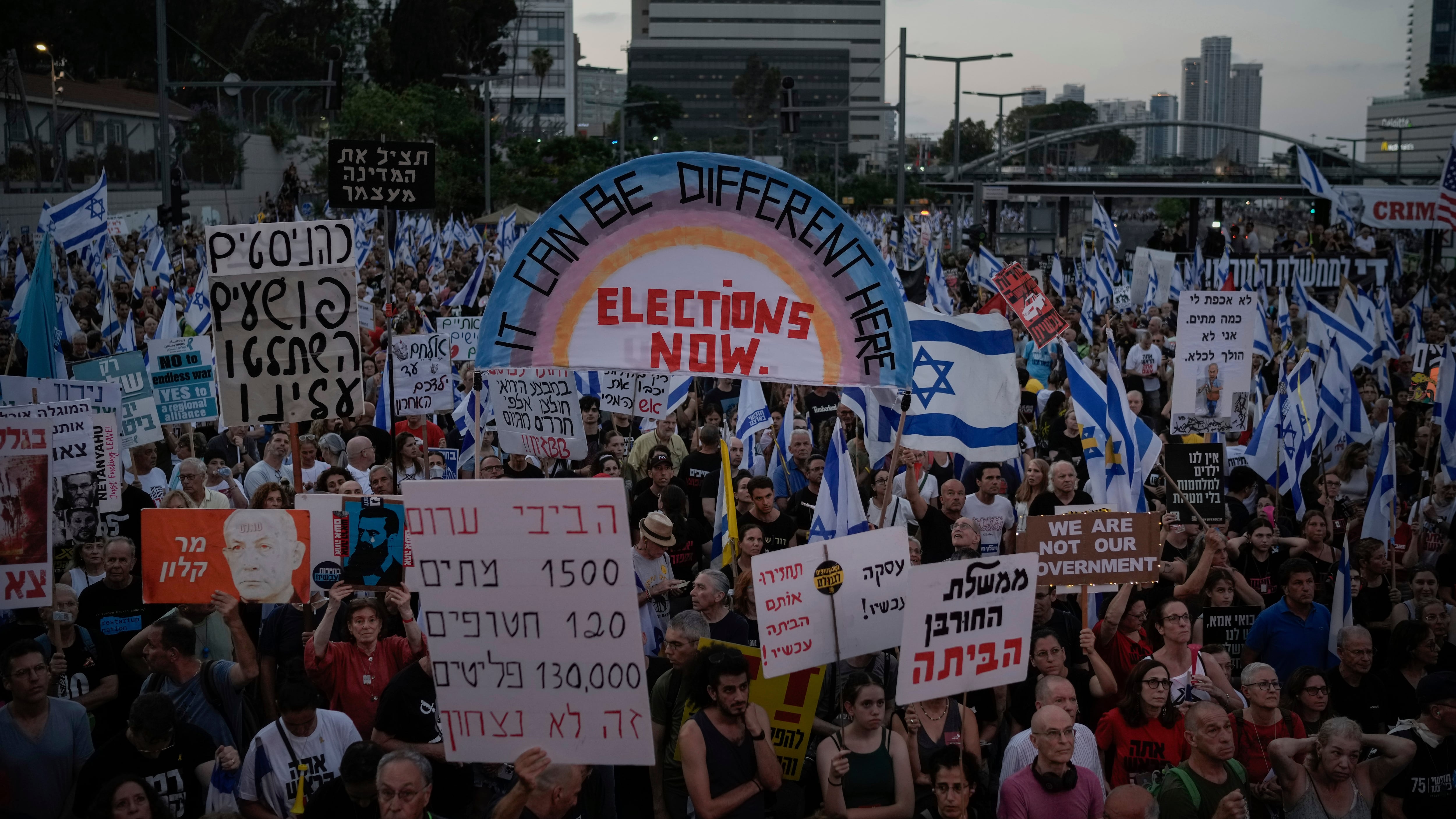 People attend a protest against Israeli Prime Minister Benjamin Netanyahu and his government, and demanding elections, in Tel Aviv (Leo Correa/AP)