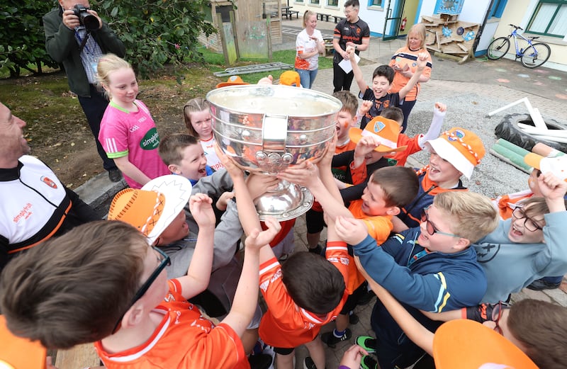 Armagh Captain Aidan Forker brings Sam Maguire to Our Lady’s Primary School Tullysaran with his team mates Stefan Campbell and Niall Grimley as they were greeted with a heroes welcome on Thursday.
PICTURE COLM LENAGHAN