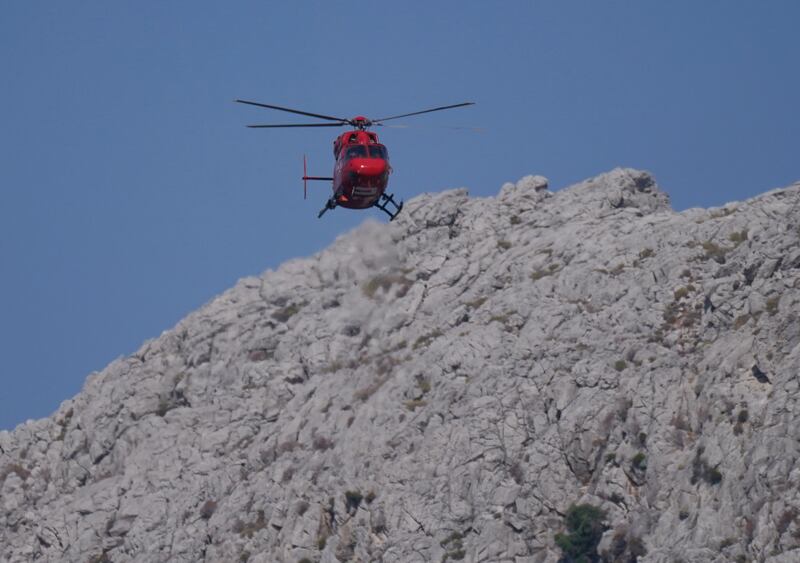 A helicopter flying over the hills in Pedi, Symi, Greece, where a search and rescue operation is under way for TV doctor and columnist Michael Mosley