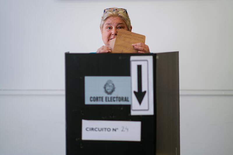 Yeni Varone, a nurse, casts her vote in the presidential run-off election in Montevideo, Uruguay (AP/Natacha Pisarenko)