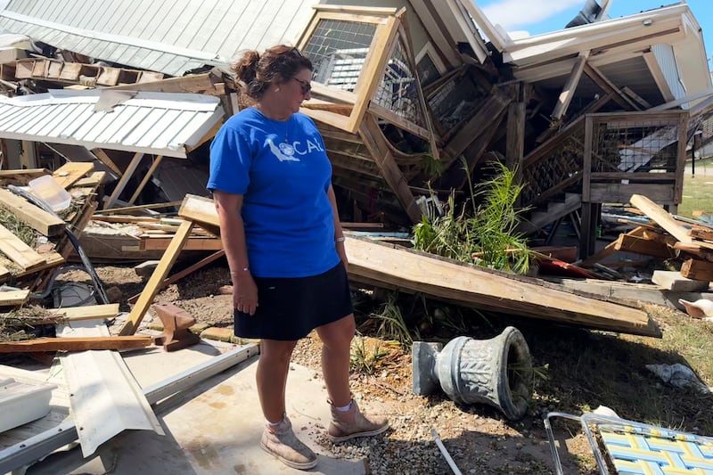 Laurie Lilliott stands amid the wreckage of her destroyed home in Dekle Beach in rural Taylor County, Florida (Kate Payne/AP)