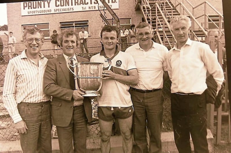 Paul McCann (centre) pictured with the Anglo Celt Cup after winning with Derry in 1987. Paul is pictured with the management team of Phil Stuart (left), Tom Scullion (second from right) and Jim McKeever (far right).