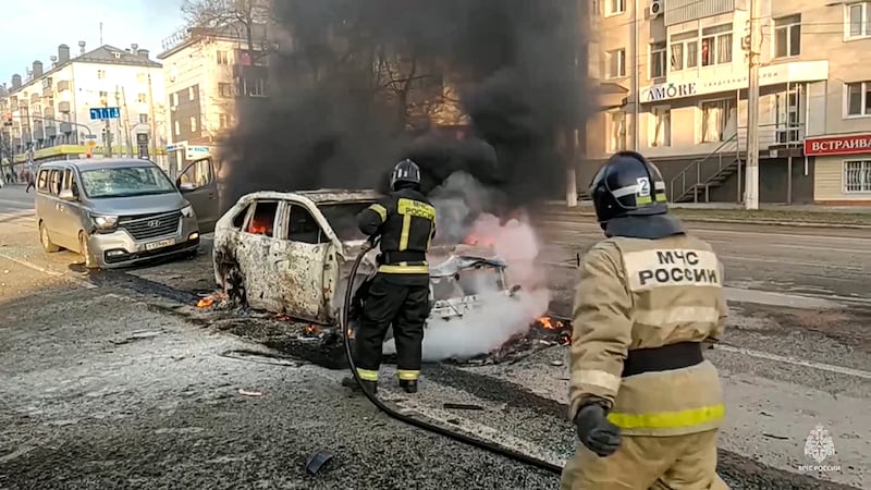 Russian firefighters extinguish burning cars after shelling in Belgorod (Russia Emergency Situations Ministry Telegram channel/AP)