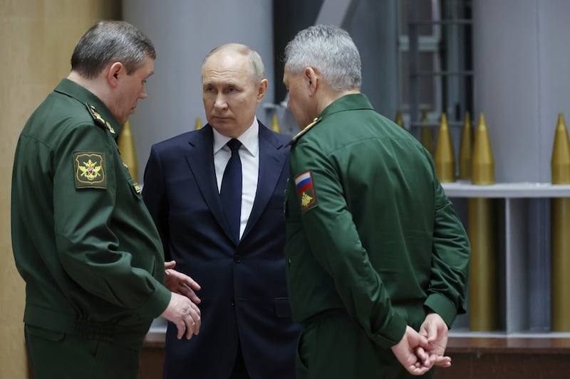 Russian President Vladimir Putin, centre, talks with Russian Chief of General Staff Gen Valery Gerasimov, left, and Russian Defence Minister Sergei Shoigu (Mikhail Klimentyev/AP)