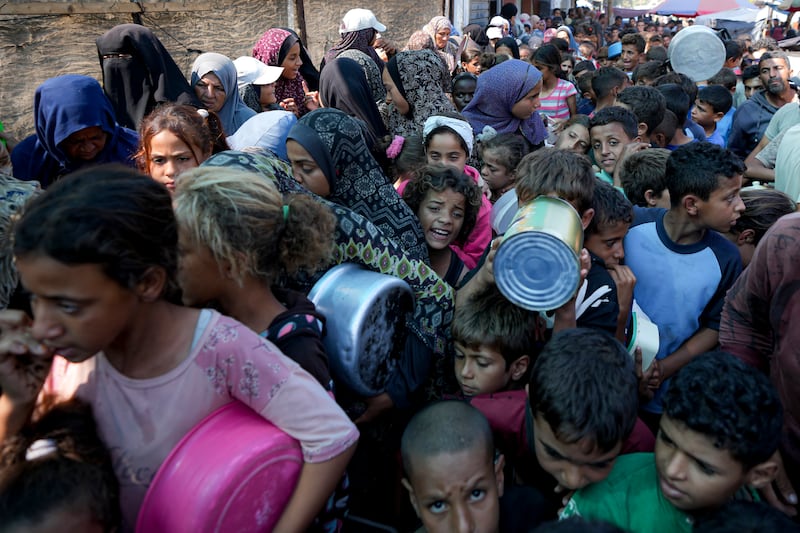 Palestinians line up for food distribution in Deir al-Balah, Gaza Strip (Abdel Kareem Hana/AP)