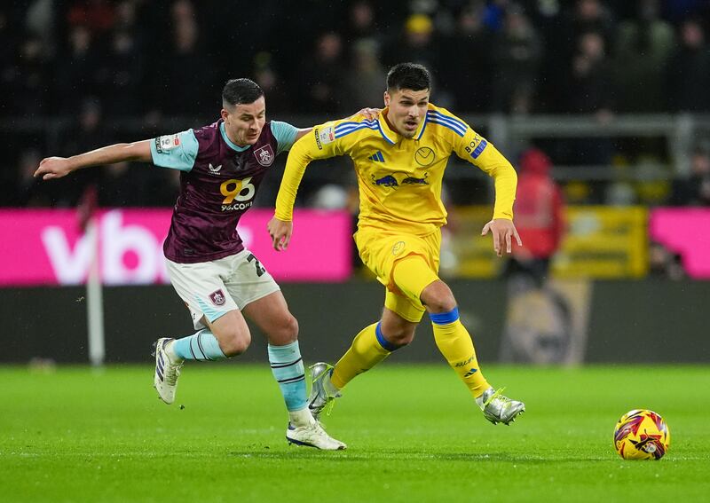 Burnley midfielder Josh Cullen (left) and Leeds forward Joel Piroe battle for the ball at Turf Moor