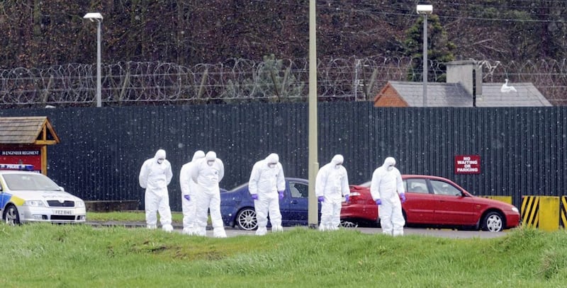 Forensic officers examine the scene outside Massereene Barracks following the murder of sappers Mark Quinsey (23) and Patrick Azimkar (21) 