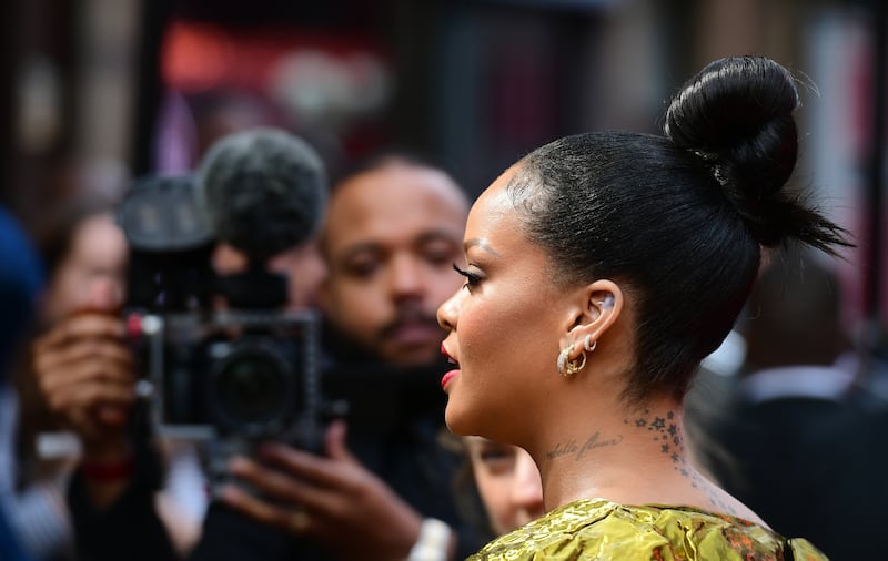 Rihanna appeared to be guarded by members of the Barbados military armed with assault rifles