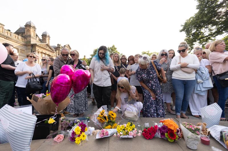 Members of the public taking part in a vigil near to the scene of the attack in Hart Street, Southport