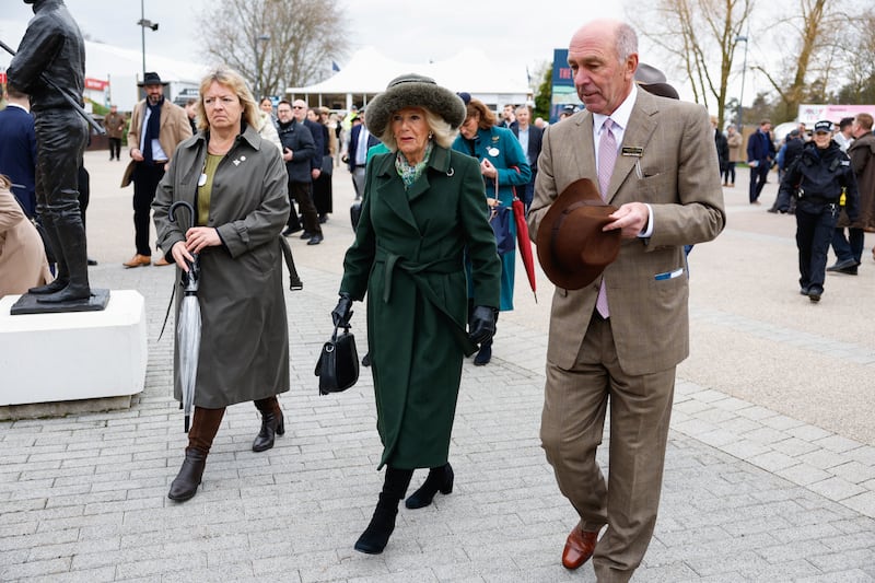 The Queen walks to the royal box with Cheltenham racecourse chairman Martin St Quinton