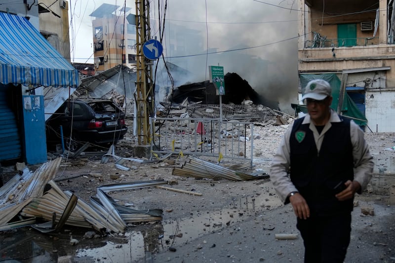 A man leaves a street after seeing the building where he was living in Dahiyeh, Beirut, Lebanon destroyed by an Israeli air strike (Hussein Malla/AP)