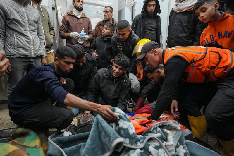 Palestinians mourn over the bodies of victims of an Israeli army strike in the Nuseirat camp at the Al-Aqsa Martyrs hospital in Deir al-Balah (Abdel Kareem Hana/AP)