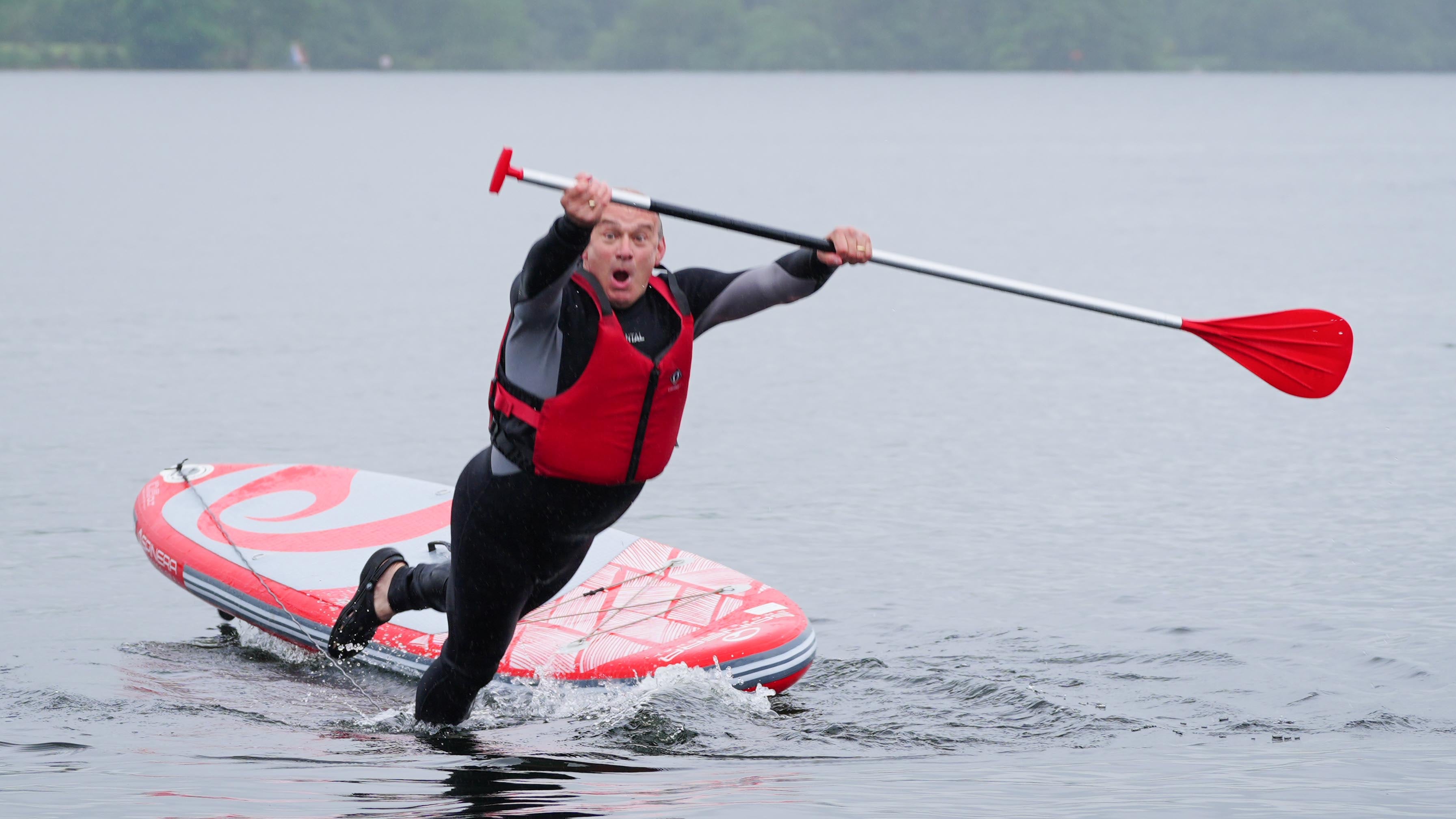 Liberal Democrat leader Sir Ed Davey topples off a paddleboard into Windermere, in the Lake District, one of several stunts he took part in on the campaign trail