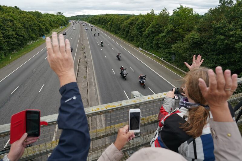 People wave as thousands of motorcyclists ride from London to Barrow