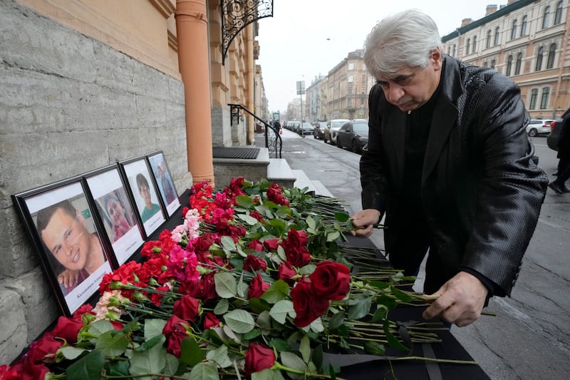 The head of the Azerbaijani diaspora in St Petersburg, Vagif Mamishev, lays flowers at the consulate of Azerbaijan in the city (Dmitri Lovetsky/AP)