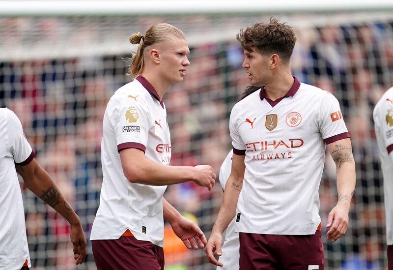 Erling Haaland, left, celebrates after scoring City’s third goal