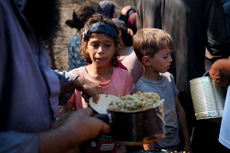 Palestinians line up for food distribution in Deir al-Balah, Gaza Strip (Abdel Kareem Hana/AP)