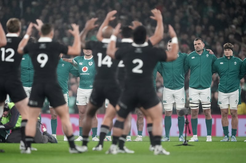 Ireland players stand as New Zealand perform the Haka