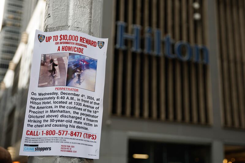 A reward poster hangs on a lamppost outside the Hilton Hotel (Stefan Jeremiah/AP)