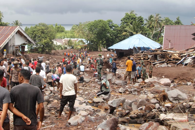 Rescuers and villagers search for those missing after a flash flood killed a number of people in Rua village on Indonesia’s Ternate Island (Rifki Anwar/AP)