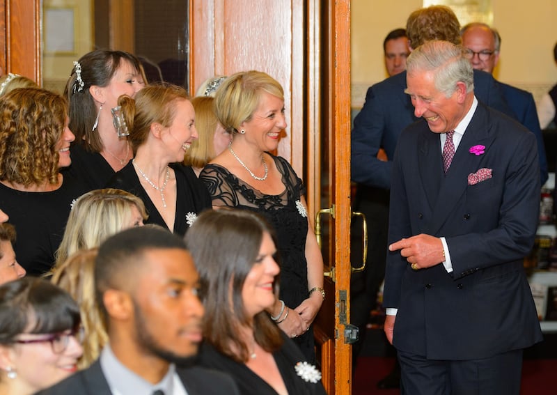 Charles as the Prince of Wales meeting members of the Military Wives choir at a Business in the Community event in 2014