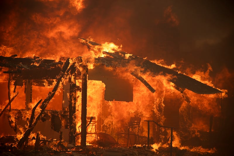 Flames engulf a structure during the Mountain Fire (Ethan Swope/AP)