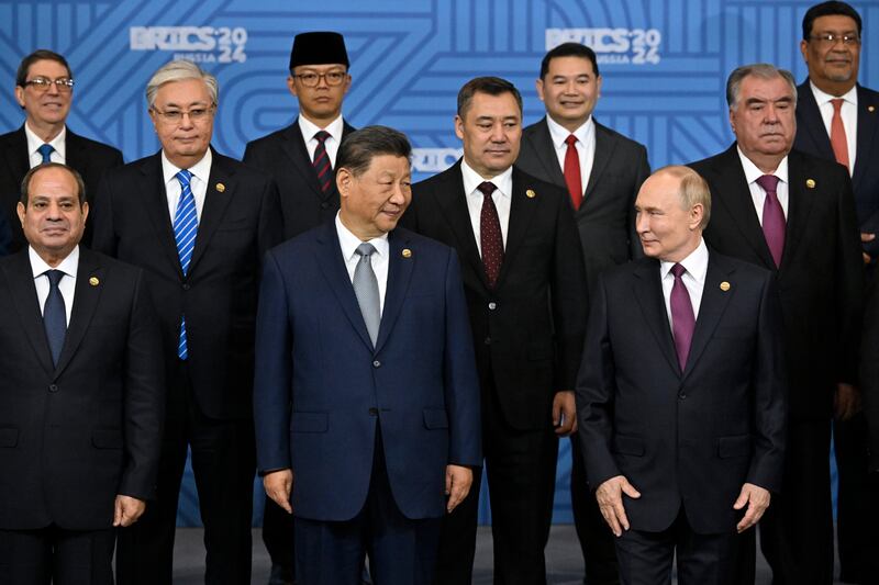 Russian President Vladimir Putin, right, and other participants pose for a photo at the Brics Summit in Kazan, Russia (Alexander Nemenov/AP)