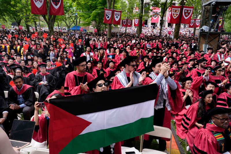 A student holds up the flag of Palestine in Harvard Yard at Harvard University (Charles Krupa/AP)