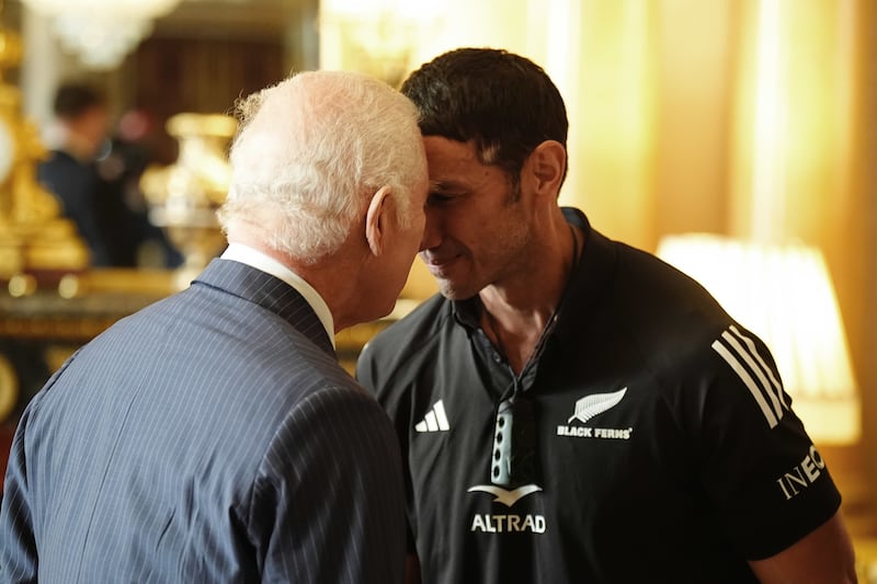 Charles performs a hongi – a traditional Maori greeting – with team manager Allan Bunting