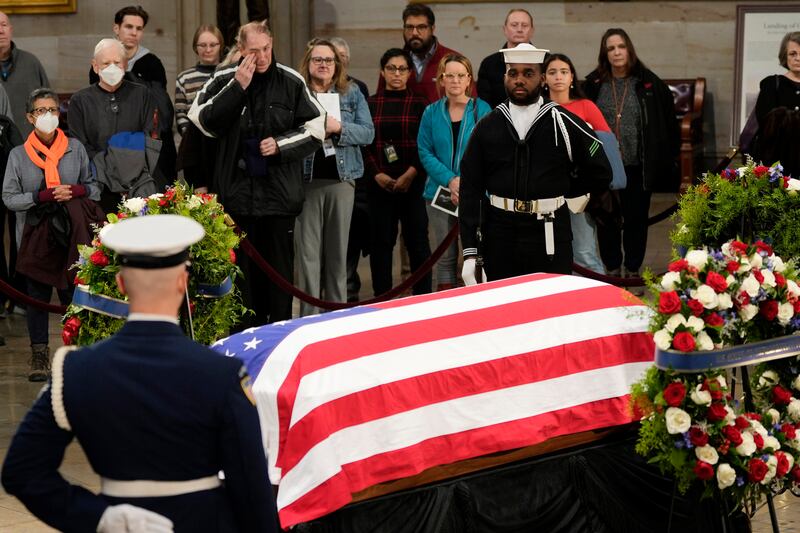 Guests pay their respects as the flag-draped casket of former President Jimmy Carter (Steve Helber/AP)