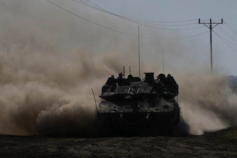 An Israeli tank moves near the Gaza Strip border in southern Israel (AP Photo/Tsafrir Abayov)