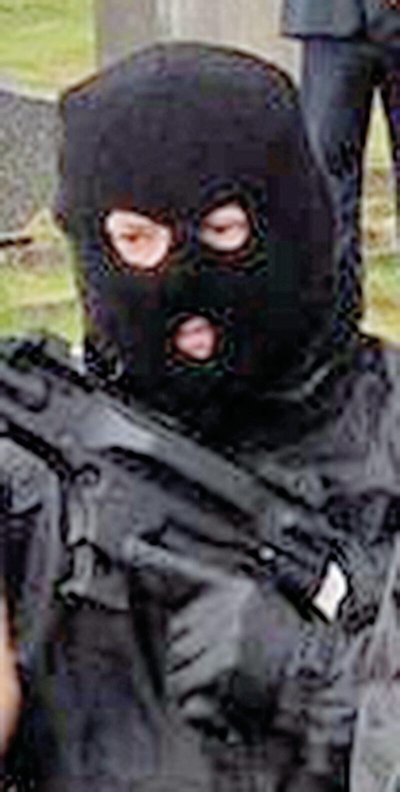 An armed and masked man at Milltown Cemetery on Easter Sunday 