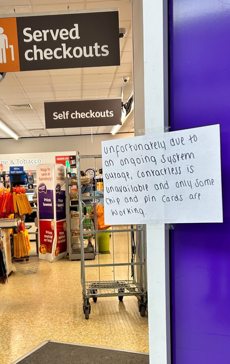 A hand-written notice informing customers of technical issues at a Sainsbury’s store in Huddersfield