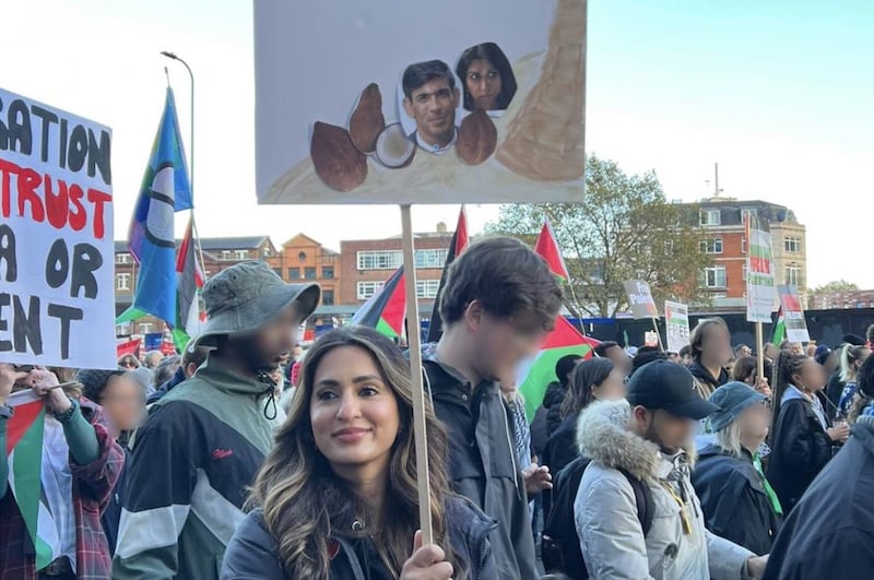 Hussain held a placard depicting Rishi Sunak and Suella Braverman as coconuts