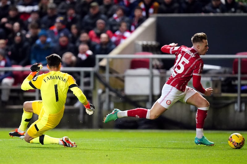 Tommy Conway, right, goes round Lukasz Fabianski before scoring Bristol City’s winner