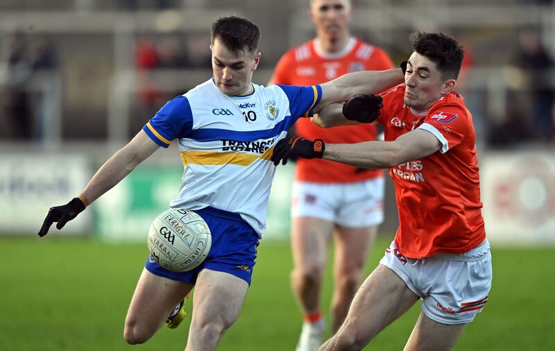 Ruairi Canavan gets his shot away under pressure from Clann Eireann's Conan O'Carroll. Picture; Oliver McVeigh